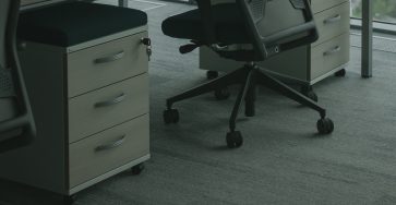 An office chair placed under its desk.
